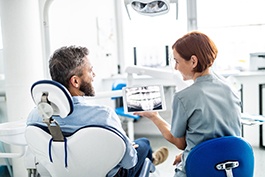 Implant dentist in Buckhead showing patient an X-ray