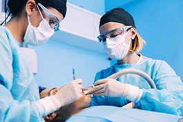 Pair of dentist performing surgery for dental implants in Buckhead