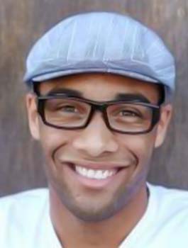 Man sporting cap and glasses grinning