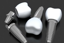 three dental implants lying on a flat surface
