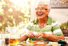 Woman with dentures eating lunch