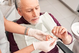 Man getting dentures at the dentist