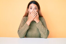 A woman covering her mouth