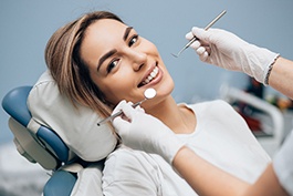 Woman smiling while sitting in dental chair