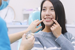 Woman smiling during her dental implant consultation