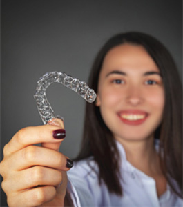 woman holding aligner