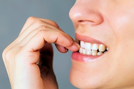 Closeup of woman biting her nails