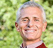 Elderly gentleman smiling surrounded by nature