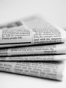 Folded newspapers stacked on top of each other