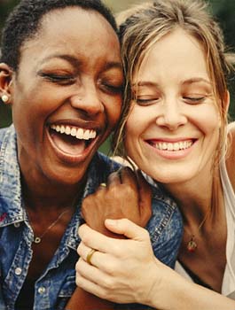 a couple smiling and hugging each other