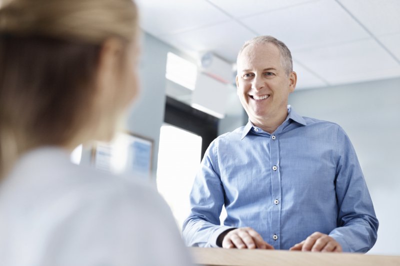 A man speaking with a dentist in Buckhead.