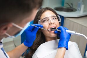 Woman with brown hair undergoing a root canal. 