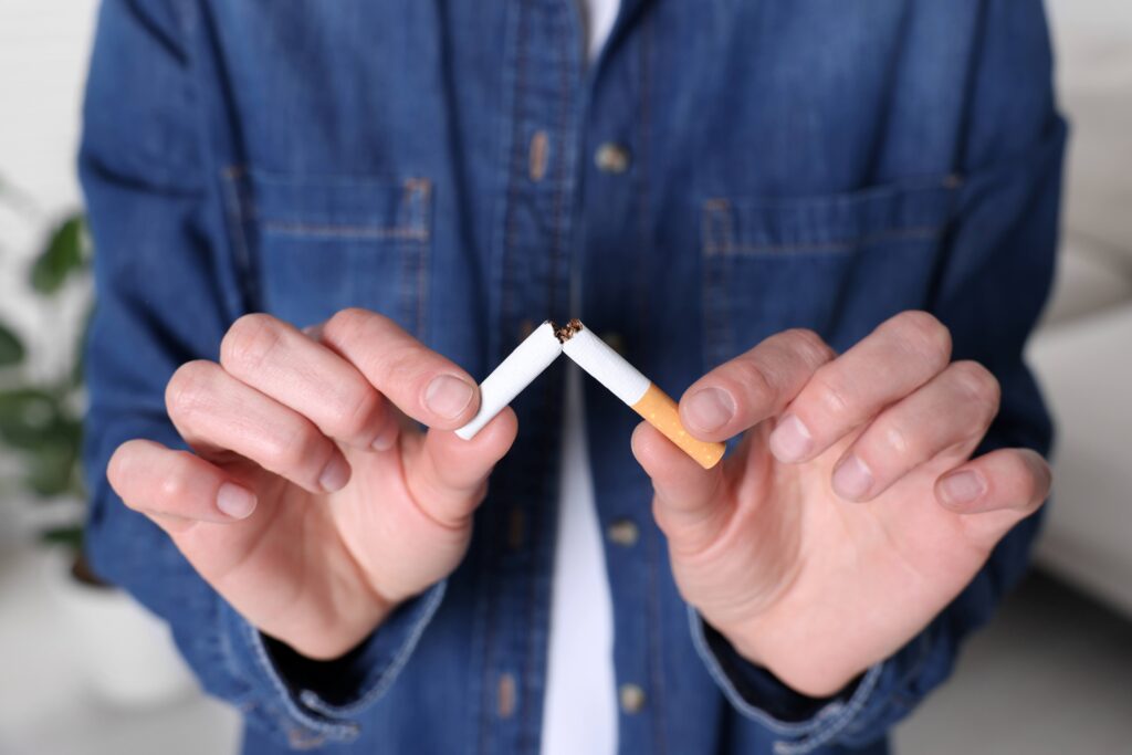 Closeup of person breaking cigarette