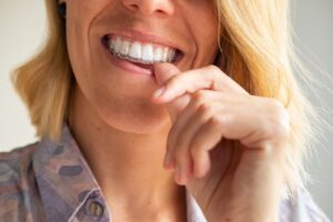Woman putting in her Invisalign tray